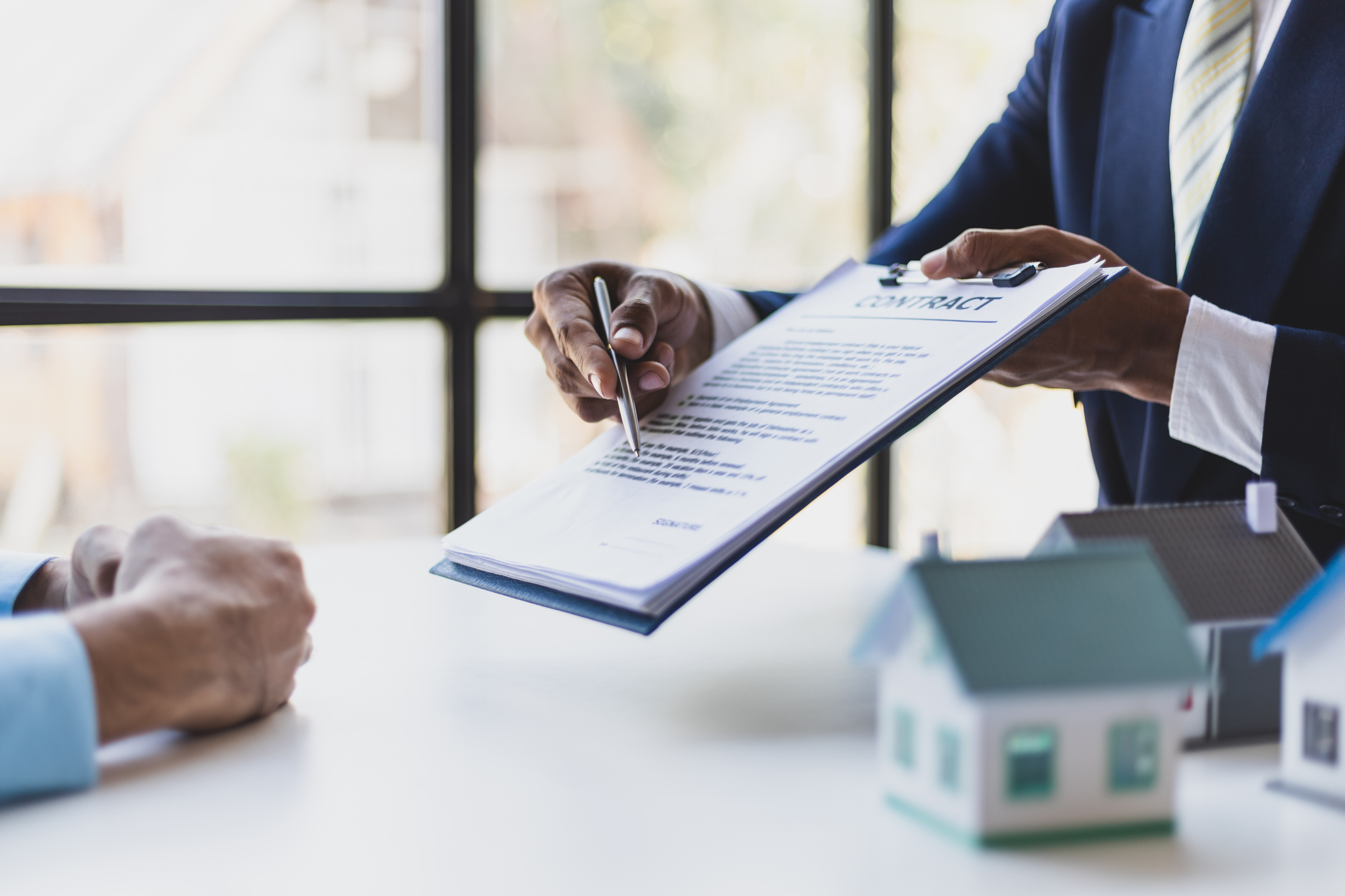 Real estate contract and pen illustrating escalation clause and buyer agent commission strategy