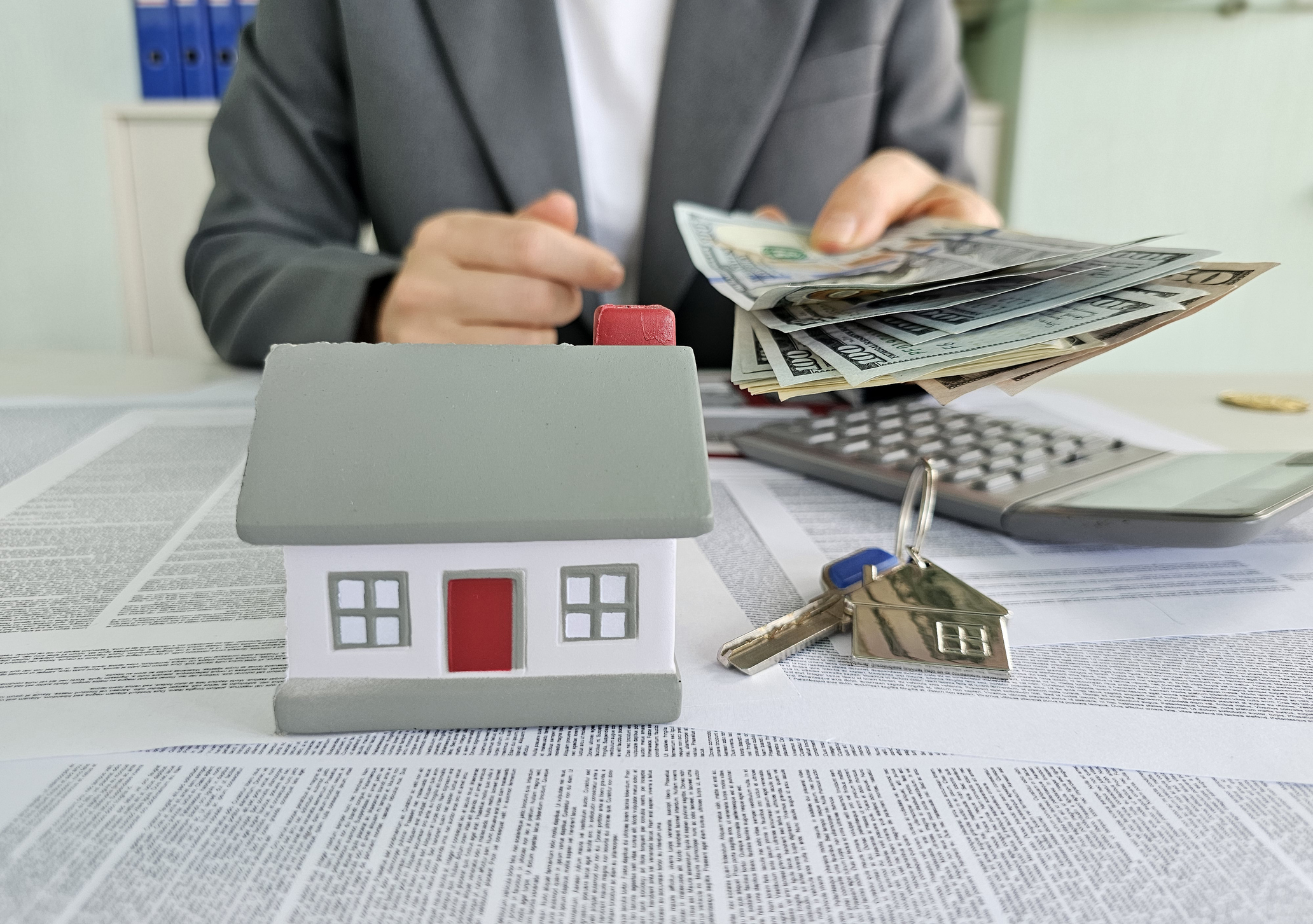 Home buyer reviewing paperwork and calculator showing how commission rebates work at closing in Colorado