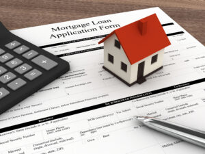 Mortgage loan application form with calculator and house model representing lender approval requirements for buyer commission rebates in Colorado