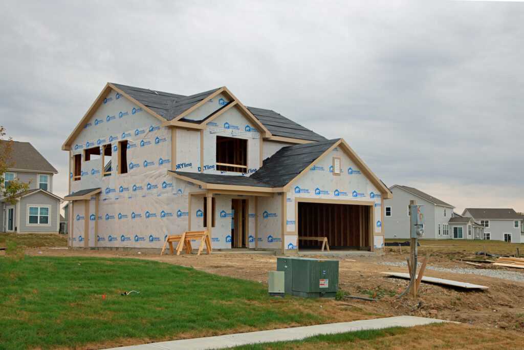 New construction home framed and wrapped on its lot